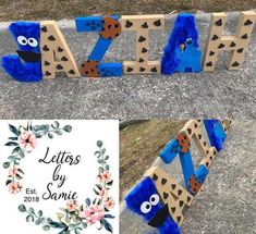 the letters are made out of wood and decorated with blue fur, flowers and leaves