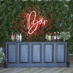 an image of a bar with bottles and flowers on the wall behind it that says boo