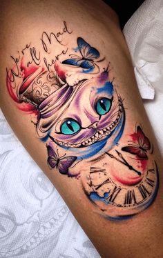 a tattoo on the leg of a woman with blue eyes and a clock in it