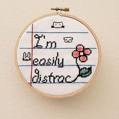 a cross stitch pattern on a hoop with the words, i'm really busy doing