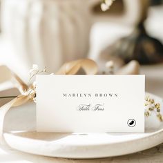 a place card sitting on top of a white plate