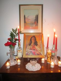 a table with candles and pictures on it