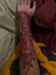 a woman's arm covered in henna