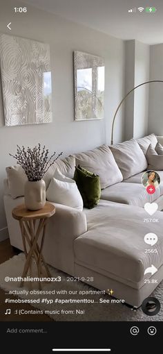 a white couch sitting in a living room next to a table