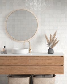 a bathroom vanity with two round mirrors above it