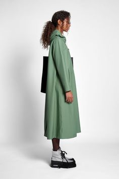 Mosebacke Long is an artisanally made knee-length and a-line-shaped raincoat for women. The sturdy and hard-wearing waterproof fabric is tailored with double-welded seams, making it impossible for any moisture to seep through. Ease of movement and comfort is achieved with under-arm eyelets and a drawstring hood. Green Raincoat With Detachable Hood For Fall, Green Parka With Detachable Hood For Rainy Weather, Green Raincoat With Adjustable Hood For Spring, Green Raincoat With Adjustable Hood For Fall, Adjustable Hood Raincoat For Workwear In Fall, Winter Long Raincoat With Detachable Hood, Adjustable Hood Fall Raincoat For Work, Winter Raincoat With Detachable Hood, Long Coat, Fall Raincoat With Adjustable Hood For Work