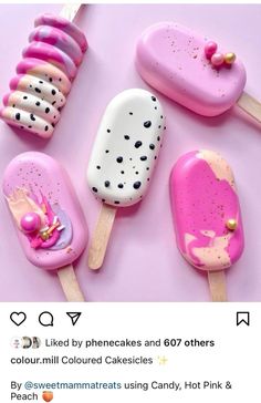 pink and white ice cream pops with gold sprinkles on them, sitting next to each other