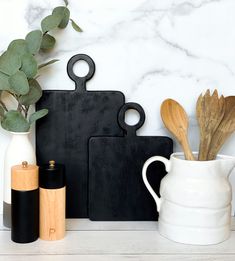 kitchen utensils and cutting board on counter with marble background