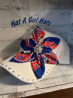 a baseball hat with a red, white and blue flower on it that says hat a girl has