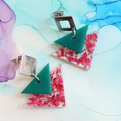 Handmade emerald green and pink foil flakes triangle resin earrings The stud part is made of stainless steel On the measurement earrings display photo: on the left are cm and on the right are inches Gifting and packaging: Each item comes carefully wrapped in tissue paper and comes in a small cardboard box to fit through the letter box. Earrings also come on branded carding I can also add a handwritten note if the item is purchased as a gift for a more personal touch. Gift wrap for special occasions is also available upon request. Should you require your order before the estimated delivery date (for a gift for example) please don't hesitate to contact me, I am always happy to help! Materials: Each item is made of resin which is very lightweight and comfortable to wear. The earrings posts ar Geometric Pink Jewelry For Gift, Geometric Pink Jewelry For Gifts, Pink Geometric Jewelry For Gift, Pink Geometric Jewelry For Gifts, Pink Triangular Jewelry For Gifts, Pink Triangle Jewelry For Gift, Pink Triangle Jewelry For Gifts, Emerald Green And Pink, Touch Gift