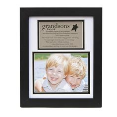 two children are smiling in front of a black and white frame with the words grandsons on it