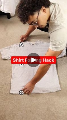 a woman is laying on the floor and making a t - shirt look like she's wearing glasses