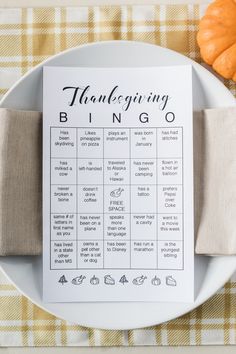 a white plate topped with a napkin and a printable thanksgiving bingo game on top of it