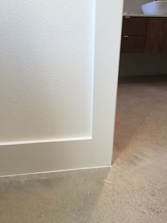 the corner of a room with a white wall