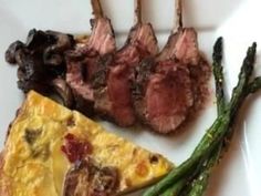 steak, asparagus and cheese on a plate next to other food items with forks