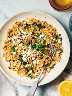 Lemon Spinach Orzo in a bowl topped with feta and dill.