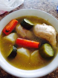 a white bowl filled with soup and vegetables