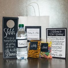 a bottle of water sitting next to some cards and other items on a counter top