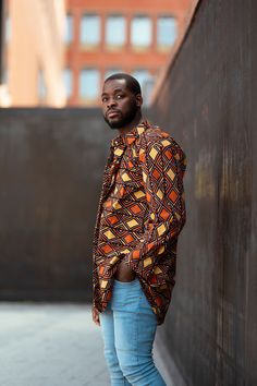 Head into Autumn in African print. This earthy tones Ankara is an Autumn classic with its seeps reds and oranges, you'll stand out from the crowd wherever you go. We Are A Brand With A Purpose. Proudly Made In Africa Feel Good in our clothing, knowing that we provide a positive social impact on the economy in West Africa. We source and produce everything in West Africa- providing over 30 full time jobs for the local community. See exactly who made your clothing directly on www.continentclothing. Casual Patterned Shirt With Bold Print, Orange Cotton Shirt With Print, Printed Brown Shirt For Fall, Patterned Long Sleeve Shirt With Vibrant Print, Long Sleeve Shirt With Vibrant Print For Fall, Casual Red Shirt With Vibrant Print, Vibrant Print Long Sleeve Shirt For Fall, Oversized Orange Long Sleeve Shirt, Oversized Orange Shirt With Long Sleeves