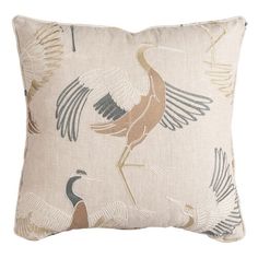 a pillow with an image of birds on the front and back of it, in neutral colors