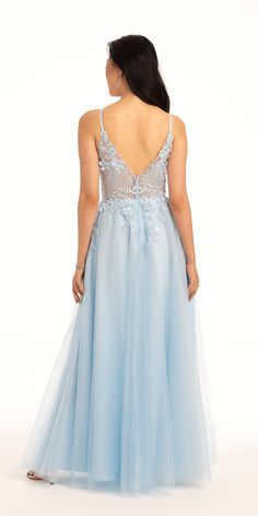 a woman in a light blue dress is looking down at the back of her dress