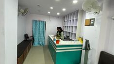 a woman sitting at a counter in a room