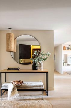 a living room with a mirror, couch and table in it's centerpiece