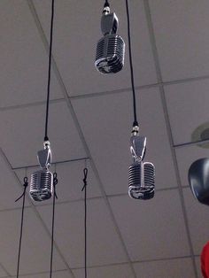 three microphones suspended from the ceiling by wires