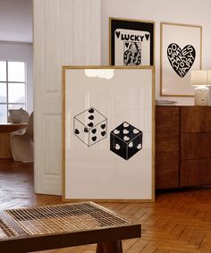 a wooden table sitting in front of a white framed poster on top of a hard wood floor