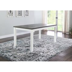 a white and grey table sitting on top of a rug