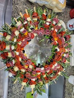 a wreath made out of meat, cheese and vegetables