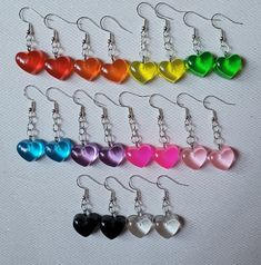 Cute Resin heart dangle earrings! They come in red, orange, yellow, green, blue, purple, neon pink, pink, clear, and black. Come in pair of one color option, but you can message for mix-ups. Earring made of hypoallergenic 925 Sterling Silver Feel free to message me with custom orders, requests, questions, or large orders. Fun Style Red Resin Earrings, Fun Red Resin Earrings, Handmade Pink Resin Heart Earrings, Handmade Heart-shaped Resin Earrings, Cheap Heart-shaped Resin Earrings, Earring Holder, Heart Dangle Earrings, Girls Fashion Clothes, Neon Pink