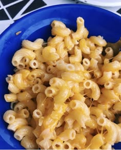 a blue bowl filled with macaroni and cheese