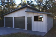 a two car garage in the middle of a yard