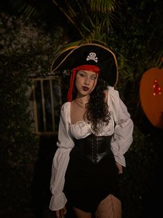 a woman dressed as a pirate posing for the camera