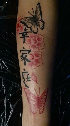 a woman's leg with flowers and butterflies tattooed on the side of her leg