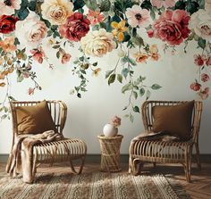 two chairs in front of a floral wall mural