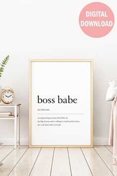 a poster with the words boss babe on it in front of a white wall and wooden floor