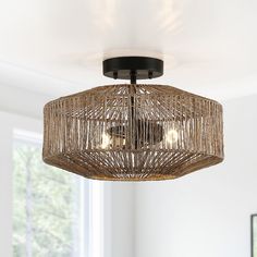 a chandelier hanging from the ceiling in a room with white walls and windows