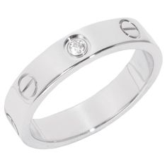 Cartier 1 Diamond 18ct White Gold Love Wedding Band Ring Brand- Cartier Model- 1 Diamond Love Wedding Band Product Type- Ring Serial Number- OX**** Age- Circa 2011 Accompanied By- Cartier Certificate Material(s)- 18ct White Gold Gemstone- Diamond UK Ring Size- K EU Ring Size- 50 US Ring Size- 5 1/4 Resizing Possible- No Gemstone Quantity- 1 Gemstone Cut- Round Brilliant Gemstone Carat Weight- est 0.02ct Band Width- 3.8mm Total Weight- 4.4g Model Number- B4050552 Condition Rating- Excellent Condition Notes- An item rated as excellent exhibits minimal to light signs of use. Cartier Mens Ring, Cartier Mens Wedding Band, Cartier Band, Cartier Men, Cartier Diamond, Silver Wedding Bands, Diamond Jewelry Designs, Wedding Band Ring, Love Wedding