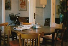 a wooden table with chairs around it