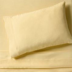 the sheets and pillowcases are made up in two different shades of light yellow