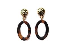 "Looking for tortoise shell earrings? These gold Celtic knot posts are also brown tortoise shell dangles. Created with gold post and acrylic beads, these Celtic posts are gold stud earrings. Oval beads measure a bit over 1/2\" wide and are almost 1\" long. Total length from the top of the post to the bottom of the bead is 1 1/2\". Lightweight, attractive and versatile, gold stud earrings, brown tortoise shell earrings make great gifts - treat someone today! All items arrive in a pretty, satin dr Sea Glass Bracelet, Oval Beads, Earring Gold, Gold Stud Earrings, Glass Bracelet, Shell Earrings, Celtic Knot, Acrylic Beads, Gold Earrings Studs