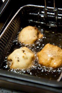 some food is being cooked in a frying pan on the stove top burner