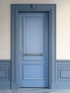 an empty room with a blue door and white walls