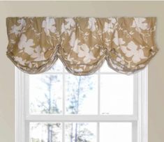 a window with a flowered valance hanging from it's side