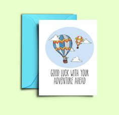 a greeting card with an illustration of two hot air balloons flying in the sky, one saying good luck with your adventure ahead