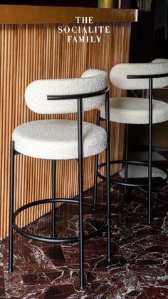 three stools sitting on top of a marble floor