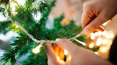 someone is stringing the lights on a christmas tree with twine ornament