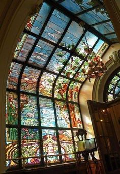 an ornate stained glass window in a building